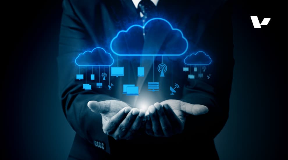 A business professional holding glowing digital clouds with various icons representing cloud computing, networking, and data storage in a futuristic style.